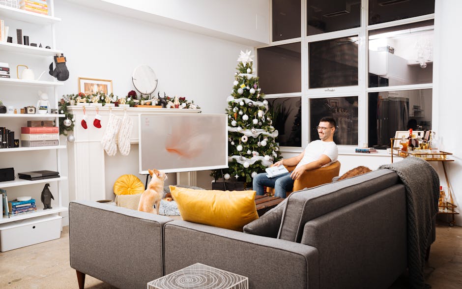 Modern living room with Christmas tree, cozy seating, and a dog in Toronto.