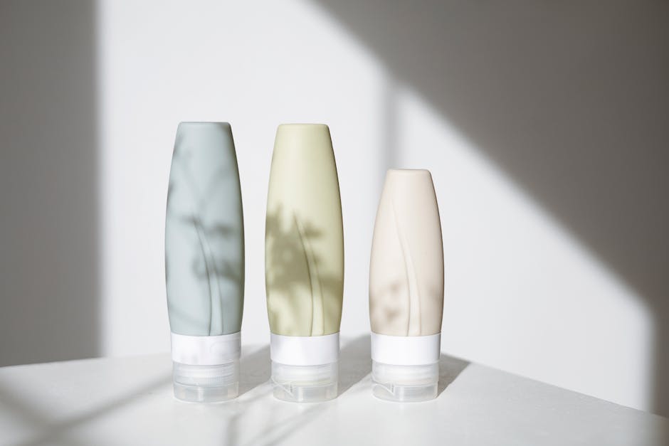 Elegant skincare bottles displayed with shadows creating a minimalist aesthetic.