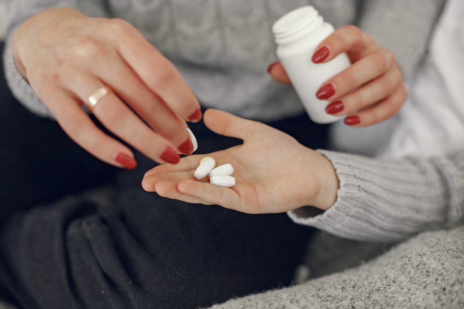A close-up of a woman handing medication to a man's hand, symbolizing care and support.