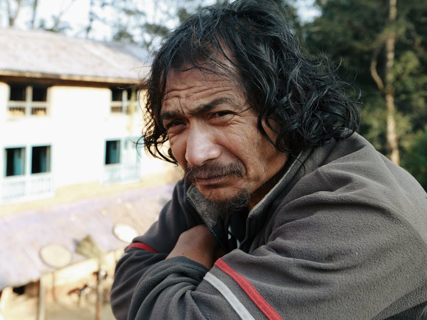 Close-up portrait of a thoughtful senior man outdoors, captured with natural lighting.